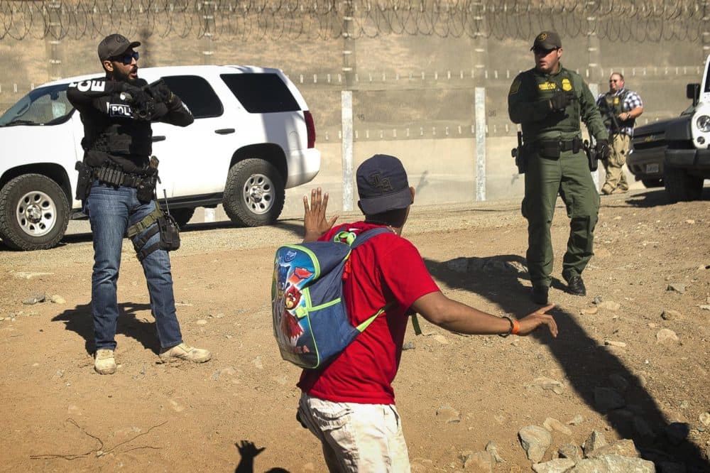 A Central American migrant is stopped by U.S. agents who order him to go back to the Mexican side of the border, after a group of migrants got past Mexican police at the Chaparral crossing in Tijuana, Mexico, Sunday, Nov. 25, 2018, at the border with San Ysidro, California. The mayor of Tijuana has declared a humanitarian crisis in his border city and says that he has asked the United Nations for aid to deal with the approximately 5,000 Central American migrants who have arrived in the city. (AP Photo/Pedro Acosta-APTOPIX)