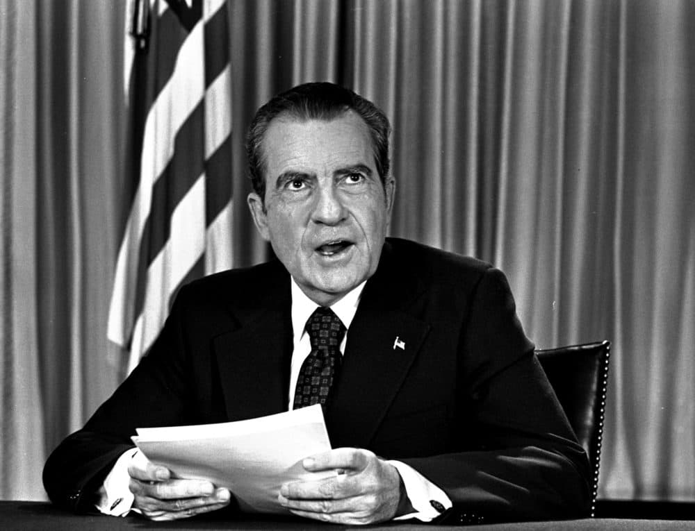 President Nixon sits in his White House office, Aug. 16, 1973, as he poses for pictures after delivering a nationwide television address dealing with Watergate. (AP Photo)