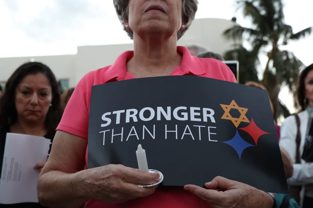 A person holds a sign that reads, 'Stronger than Hate,'  during a vigil at the Holocaust Memorial Miami Beach to remember the victims of a mass shooting at a synagogue in Pittsburgh. (Joe Raedle/Getty Images)