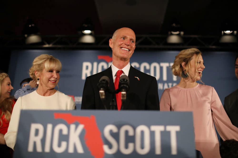 Florida Gov. Rick Scott takes the stage as he stands with his wife Ann Scott (left) and daughter Alison Guimard (right) during his election night party at the LaPlaya Beach & Golf Resort on Tuesday in Naples, Fla. (Joe Raedle/Getty Images)