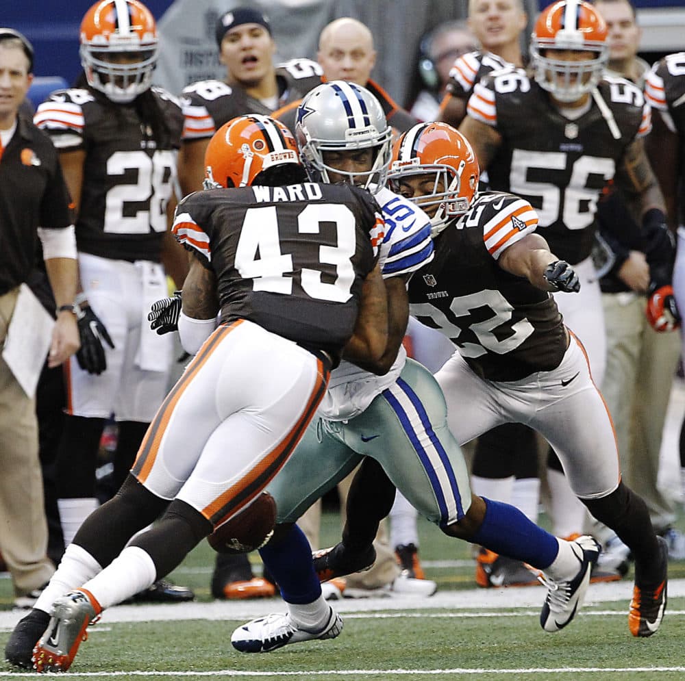 Cleveland Browns safety T.J. Ward hits Dallas Cowboys wide receiver Kevin Ogletree as Browns cornerback Buster Skrine helps tackle during the second half of an NFL football game in 2012. (AP/Brandon Wade, File)