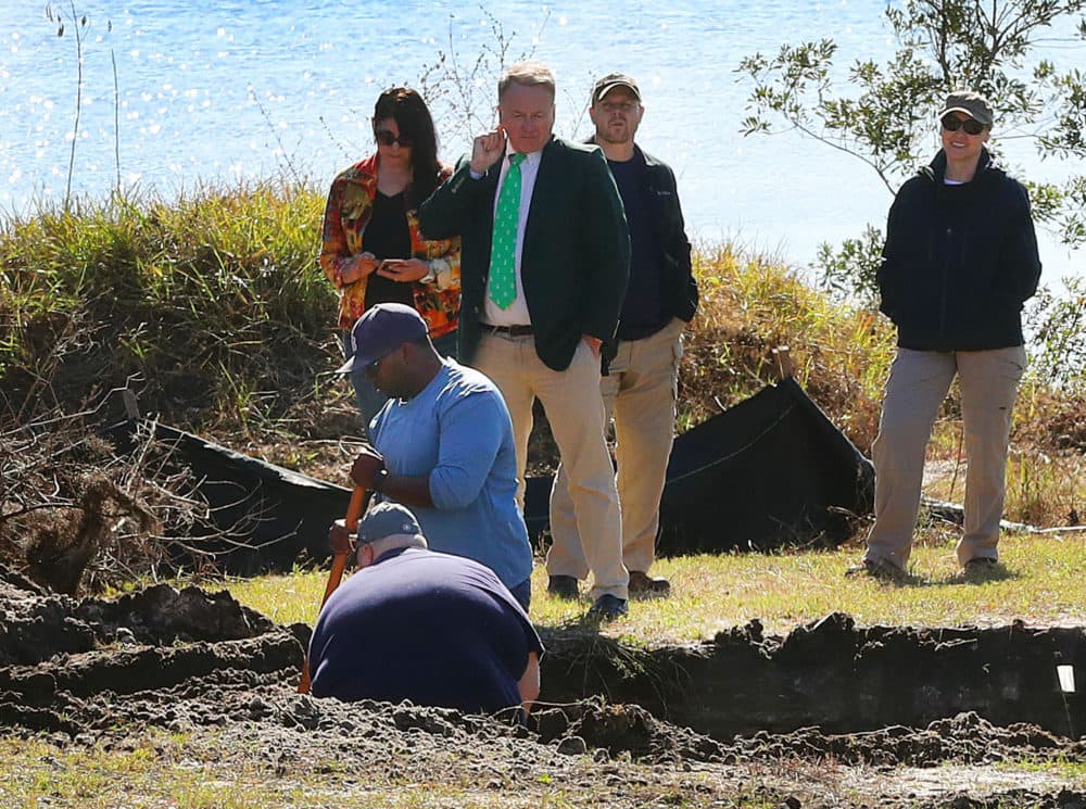 John Bill, in a green tie, watches as the FBI and other investigators observe the excavation of a lot in Florida in hopes of finding the stolen Isabella Stewart Gardner Museum artwork on Jan. 31, 2018. (John Tlumacki/Globe Staff)