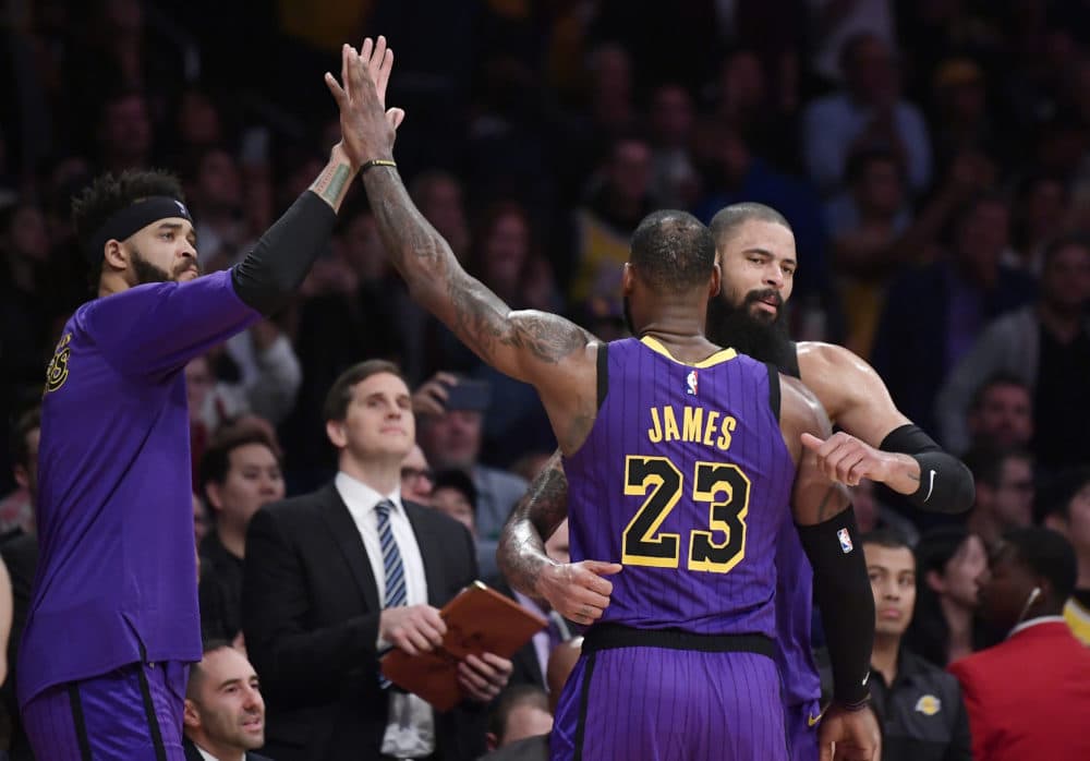 Los Angeles Lakers forward LeBron James is congratulated by teammates after he passed Wilt Chamberlain for fifth place in career points on Wednesday. (AP/Mark J. Terrill)