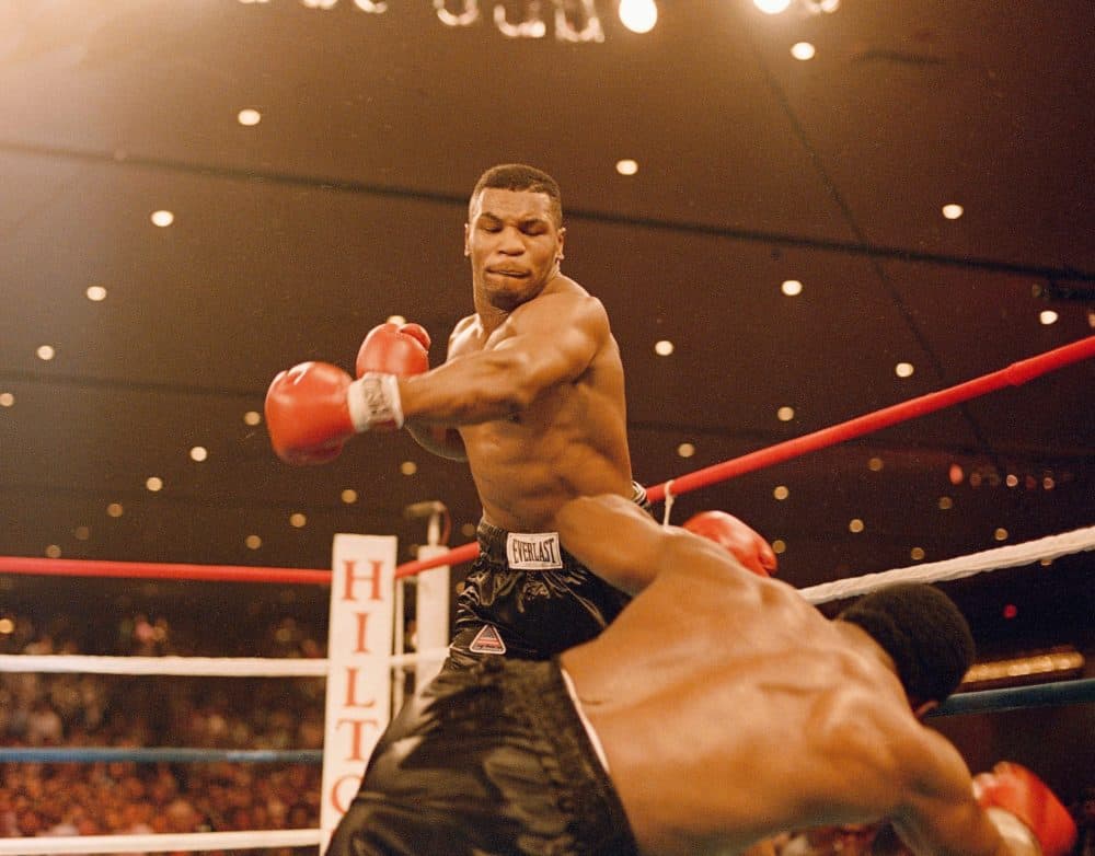 Mike Tyson knocks down Trevor Berbick, November 22, 1986. It took Tyson two rounds to become, at age 20, the youngest heavyweight champion ever. (AP)