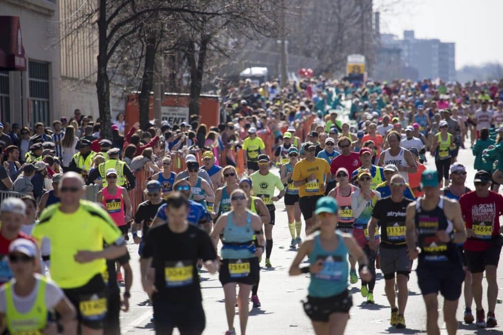 Hundreds of runners pour into Kenmore Square at mile 25 of the Boston Marathon. (Jesse Costa/WBUR)
