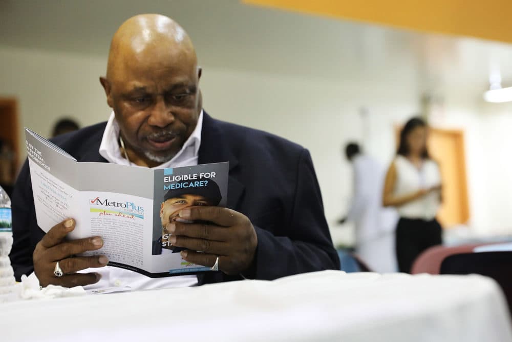 A man reads literature on Medicare at an event sponsored by MetroPlus, a prepaid health services plan, on June 23, 2017 in New York City. The Harlem seniors were provided with Medicare education and health care options at the event. (Spencer Platt/Getty Images)