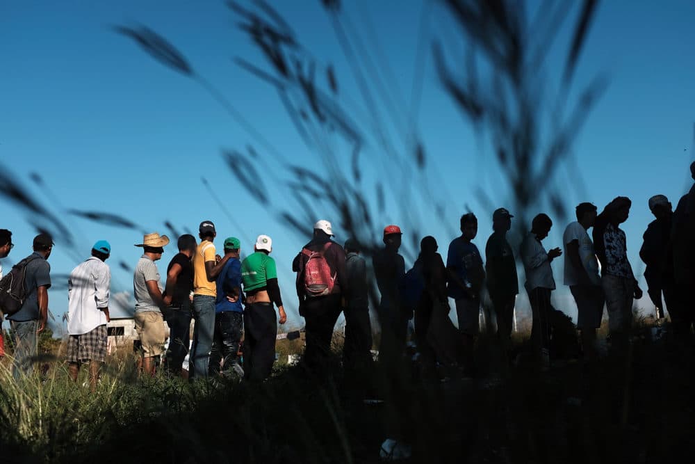 Members of a Central American migrant caravan wait in line for food and other items while in a camp on Oct. 31, 2018 in Juchitan, de Zaragoza, Mexico. (Spencer Platt/Getty Images)