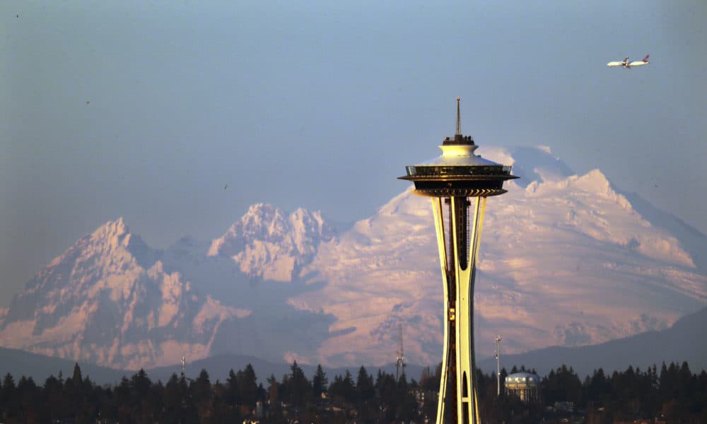 Mount Baker is seen some 85 miles distant behind the Space Needle under clear skies at sunset Thursday, Dec. 6, 2018, from Seattle. (Elaine Thompson/AP)