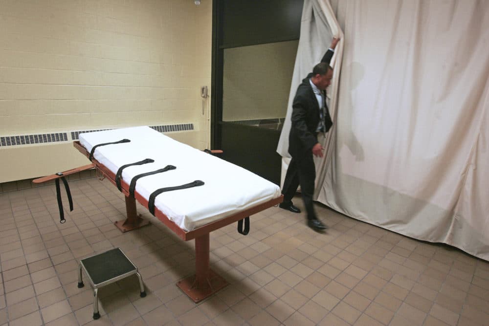 In this November 2005 file photo, Larry Greene, public information director of the Southern Ohio Correctional Facility, demonstrates how a curtain is pulled between the death chamber and witness room at the prison in Lucasville, Ohio. (Kiichiro Sato/AP)