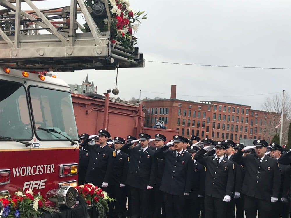 A procession of firefighters lines up in Worcester to pay their respects to fallen firefighter Christopher Roy at his funeral on Saturday. (Quincy Walters/WBUR)