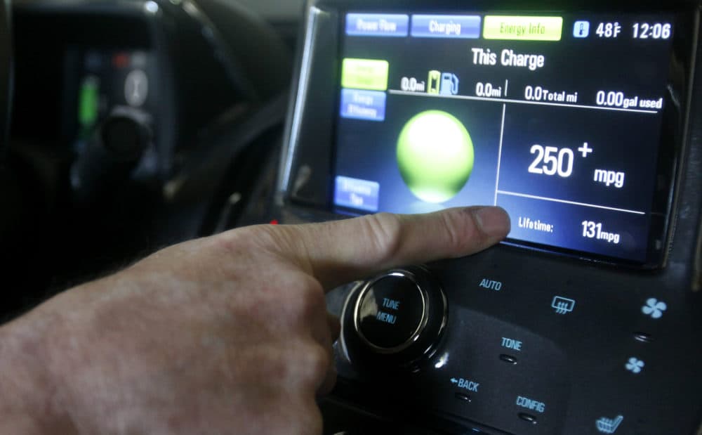 Felix Kramer, founder of CalCars, points to the miles per gallon displayed in his new Chevy Volt electric car in Redwood City, Calif., Wednesday, Dec. 29, 2010. (AP Photo/Jeff Chiu)