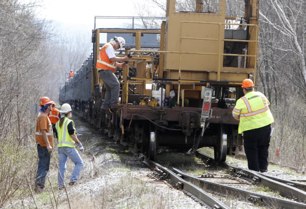 In this April 2011 file photo, workers install new track in Richmond, Vt., the result of upgrades to 220 miles of New England Central Railroad track funded in 2010 by a $50 million federal stimulus grant. A similar grant will be given to Massachusetts for updates to freight rail in the Western part of the state (Toby Talbot/AP File Photo)