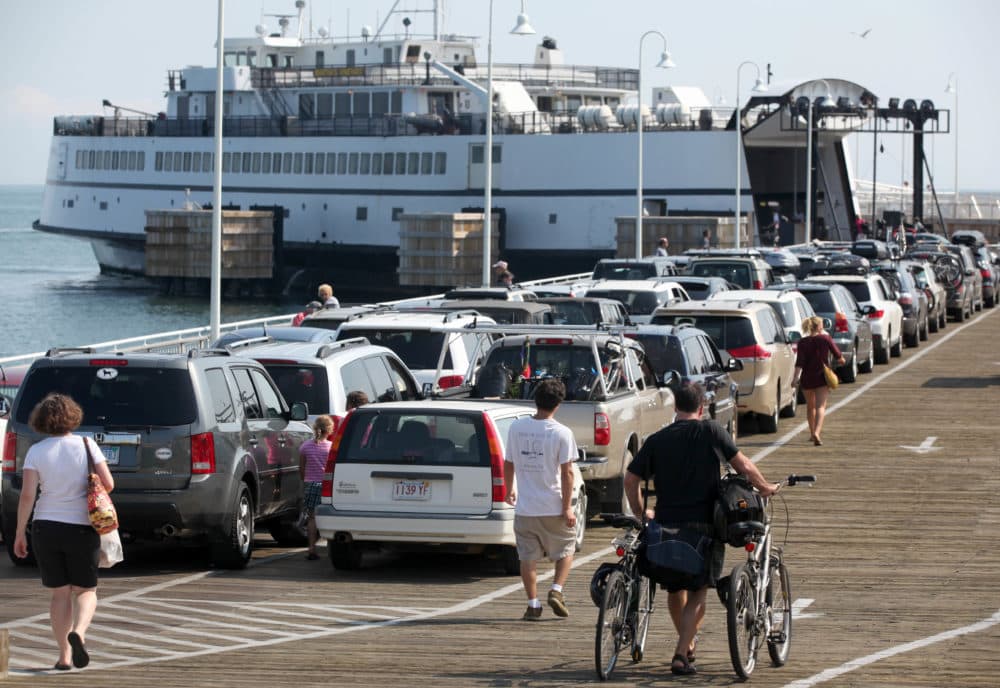 Passengers with cars and bicycles prepare to board a ferry departing the island of Martha's Vineyard, in Oak Bluffs on Aug. 26, 2011. (Steven Senne/AP)