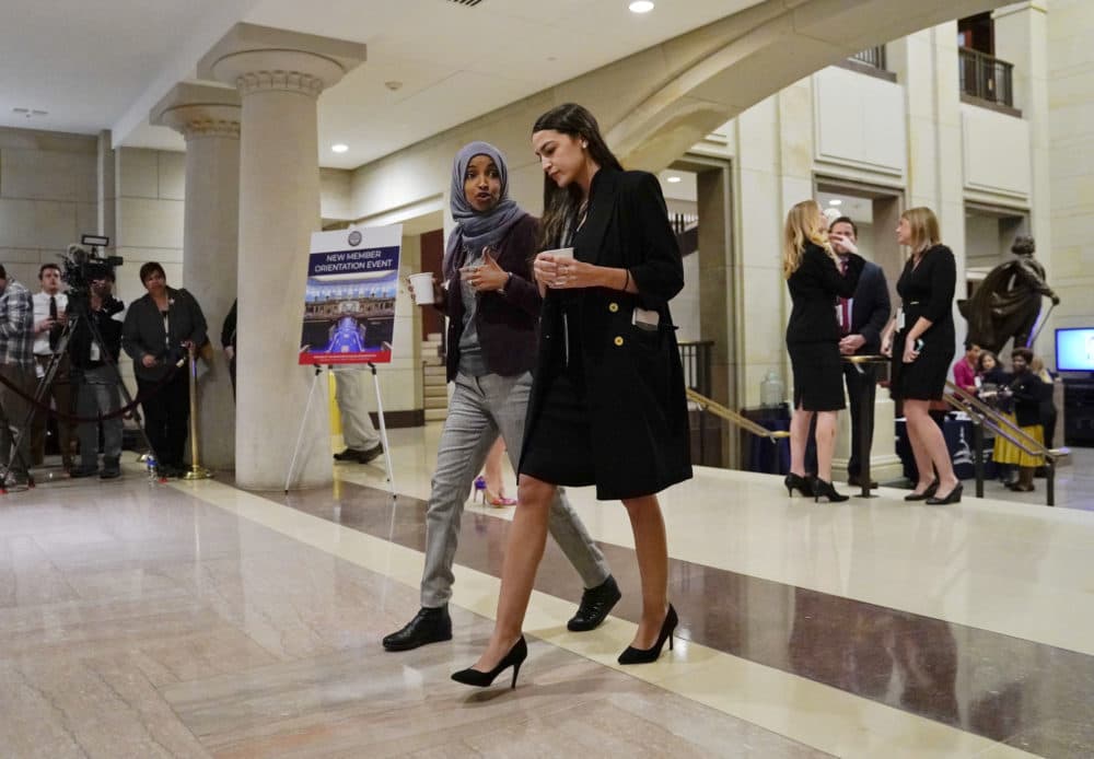 Rep.-elect Alexandria Ocasio-Cortez, D-N.Y., right, walks and talks with Rep.-elect IIhan Omar, D-Minn., left, prior to a member-elect briefing on Capitol Hill in Washington. (Pablo Martinez Monsivais/AP)