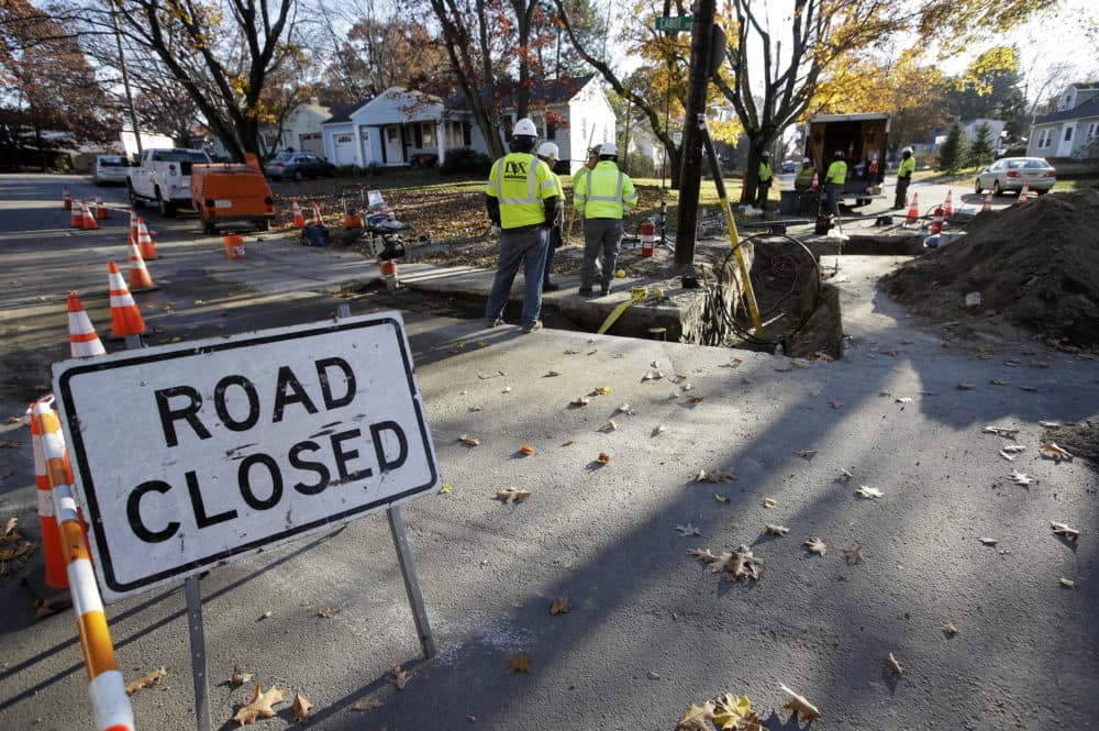 On Nov. 8, natural gas contract workers repair underground gas lines in Lawrence. (Steven Senne/AP)