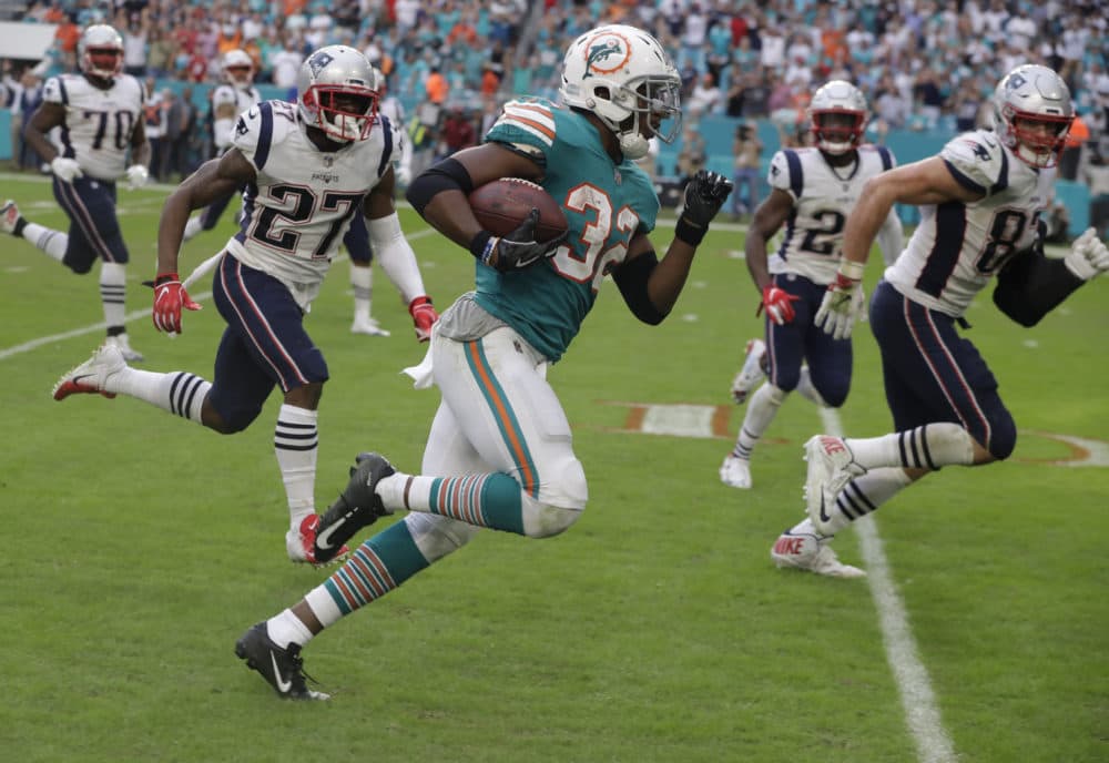 Miami Dolphins running back Kenyan Drake (32) runs for a touchdown during the second half of an NFL football game against the New England Patriots, Sunday, Dec. 9, 2018, in Miami Gardens, Fla. The Dolphins defeated the Patriots 34-33. (Lynne Sladky/AP)