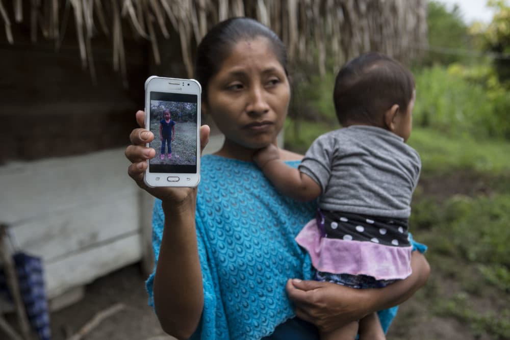 Claudia Maquin, 27, shows a photo of her daughter, Jakelin Amei Rosmery Caal Maquin in Raxruha, Guatemala, on Dec. 15, 2018. The 7-year-old girl died in a Texas hospital, two days after being taken into custody by border patrol agents in a remote stretch of New Mexico desert. (Oliver de Ros/AP)