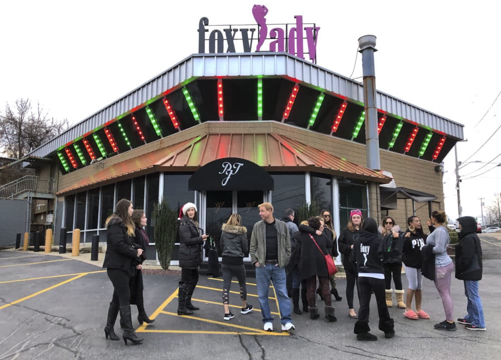 Former workers gather outside the Foxy Lady strip club, Thursday, Dec. 20, 2018, in Providence, R.I. The city ordered the club to close on Wednesday. A city board voted to revoke its licenses after police charged three dancers with prostitution the previous week. (Michelle R. Smith/AP)