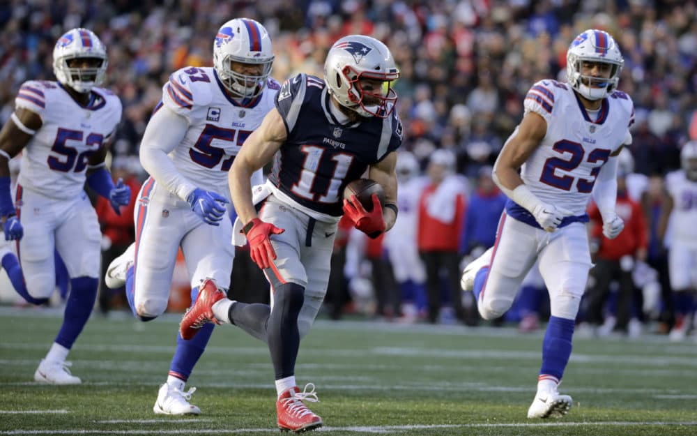 New England Patriots wide receiver Julian Edelman (11) runs from Buffalo Bills defenders Corey Thompson, left, Lorenzo Alexander and Micah Hyde, right, on his way to a touchdown after catching a pass during the second half of an NFL football game, Sunday, Dec. 23, 2018, in Foxborough, Mass. (Elise Amendola/AP)