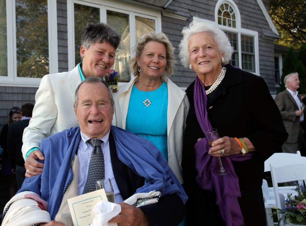 In this Sept. 21, 2013 photo, former President George H.W. Bush, front left, former first lady Barbara Bush, right, pose for photos after the wedding of longtime friends Helen Thorgalsen, center, and Bonnie Clement, in Kennebunkport, Maine. Bush was an official witness at the same-sex wedding, his spokesman said Wednesday, Sept. 25, 2013. (Susan Biddle/AP)