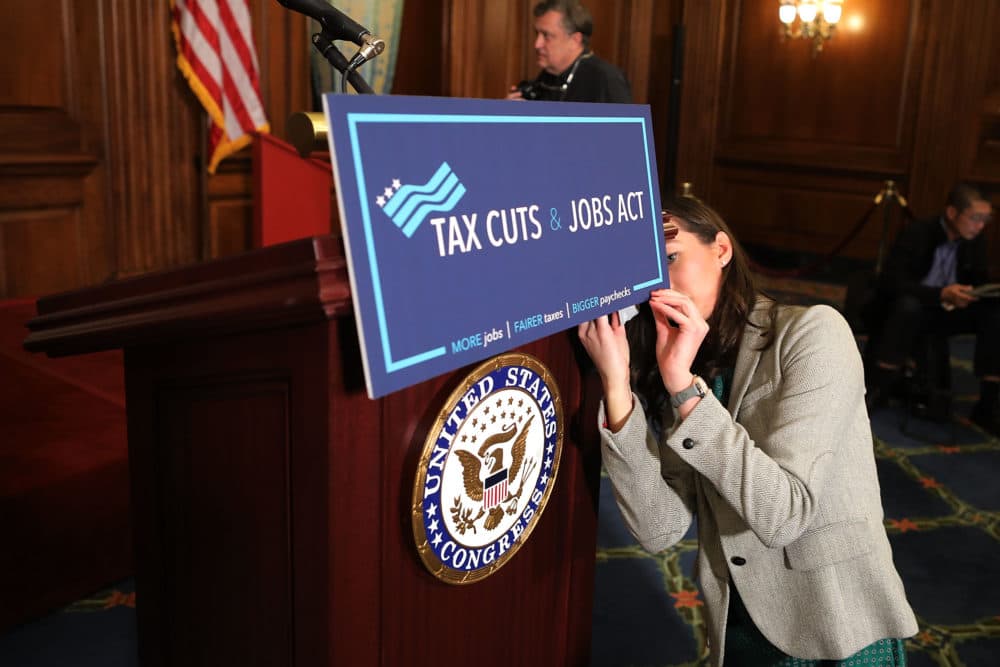 A staffer for Speaker of the House Paul Ryan prepares signage as the House votes on the Tax Cuts and Jobs Act at the U.S. Capitol on Nov. 16, 2017 in Washington, D.C. (Chip Somodevilla/Getty Images)