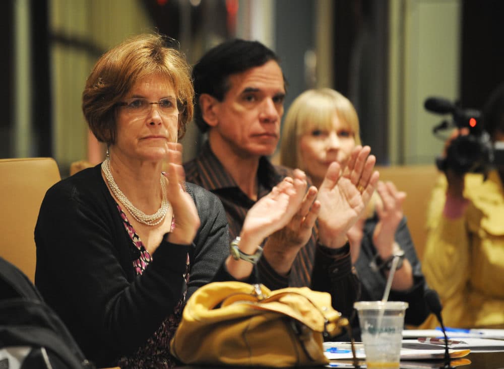 Ilene Kent (left) co-founder of Madoff Survivors Group, Richard Friedman (center) and a woman who did not want to be identified clap after lawyer Howard Elisofon (not pictured) spoke on behalf of victims of Bernard Madoff, June 24, 2009 at the law offices of Herrick, Feinstein in New York. (Stan Honda/AFP/Getty Images)
