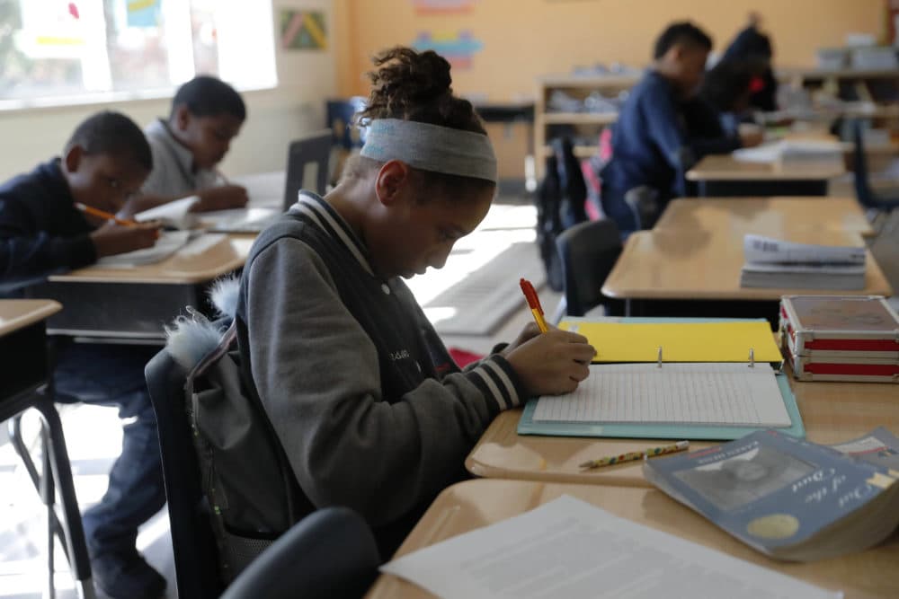 In this Tuesday, Dec. 18, 2018 photo, Breanna Johnson works on her assignment in her 6th-grade English class at Alice M. Harte Charter School in New Orleans. Charter schools, which are publicly funded and privately operated, are often located in urban areas with large back populations, intended as alternatives to struggling city schools. (Gerald Herbert/AP)