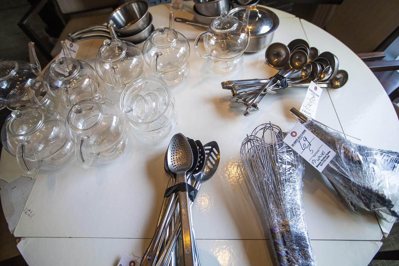 Kitchen utensils and assorted glassware up for auction at the L'Espalier auction. (Jesse Costa/WBUR)