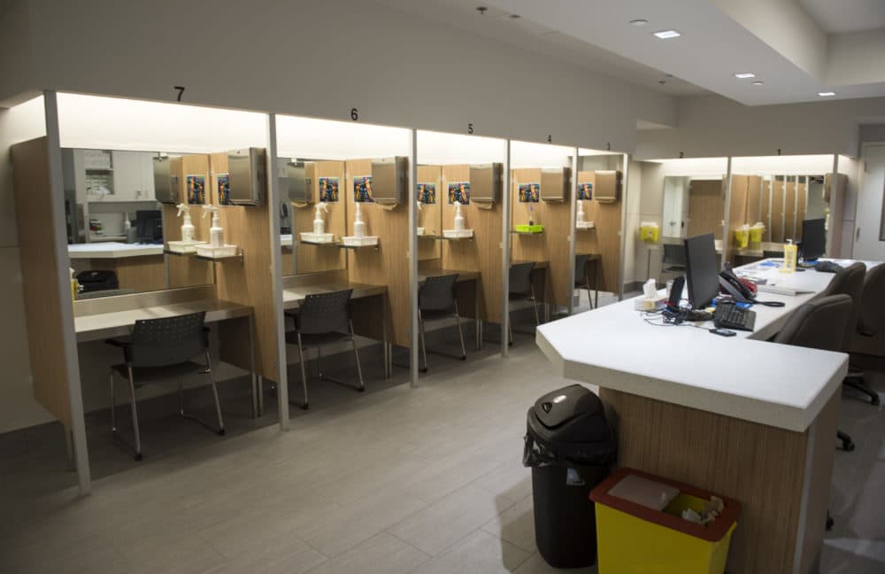 In this June 2017 photo, booths line the Cactus &quot;safe injection site,&quot; where drug addicts can shoot up using clean needles, get medical supervision and freedom from arrest, in Montreal. (Paul Chiasson/The Canadian Press via AP)