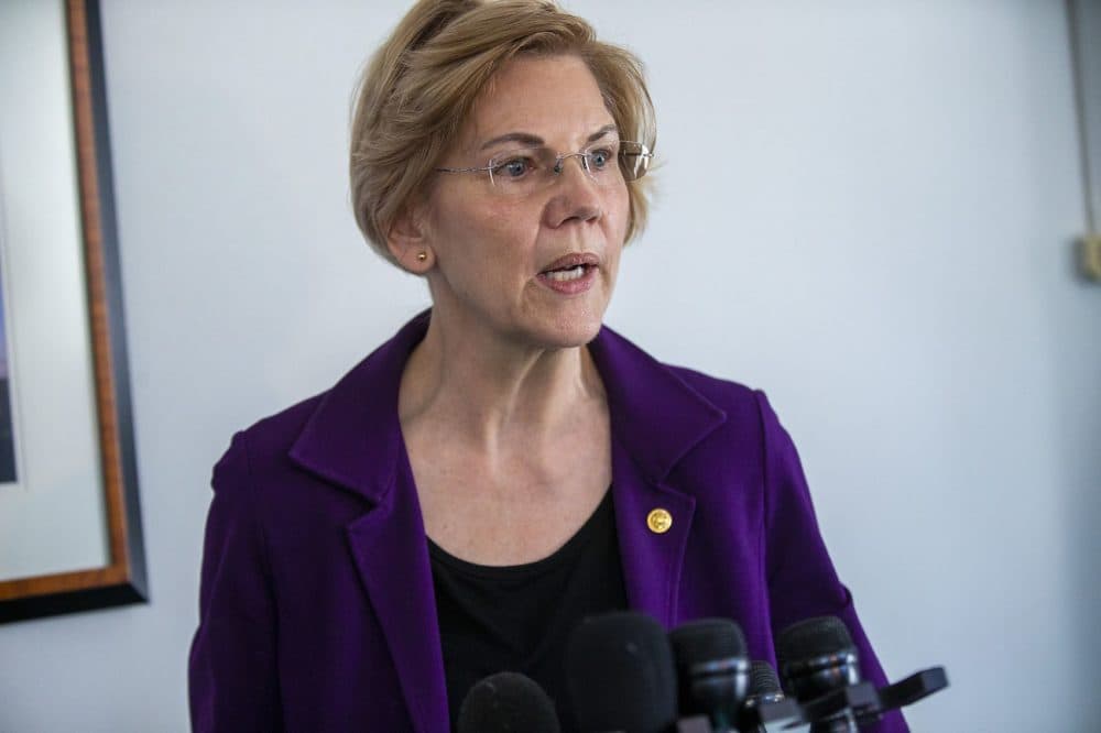 U.S. Seantor Elizabeth Warren answers questions from the news media after meeting with federal workers who were out of work during the recent government shutdown at the JFK Federal Building in Boston . (Jesse Costa/WBUR)