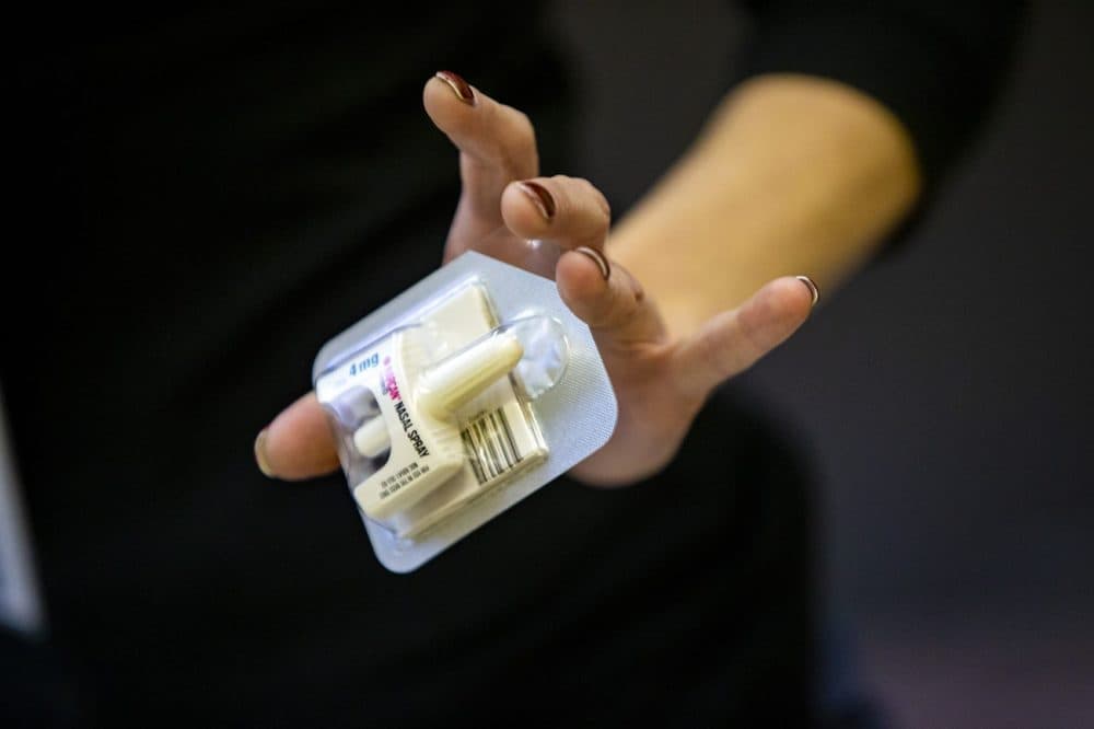 Amy Delaney, program manager at Boston Public Health, holds a single dose of Narcan nasal spray at the Overdose Prevention & Naloxone Training Program at Boston Medical Health Clinic. (Jesse Costa/WBUR)