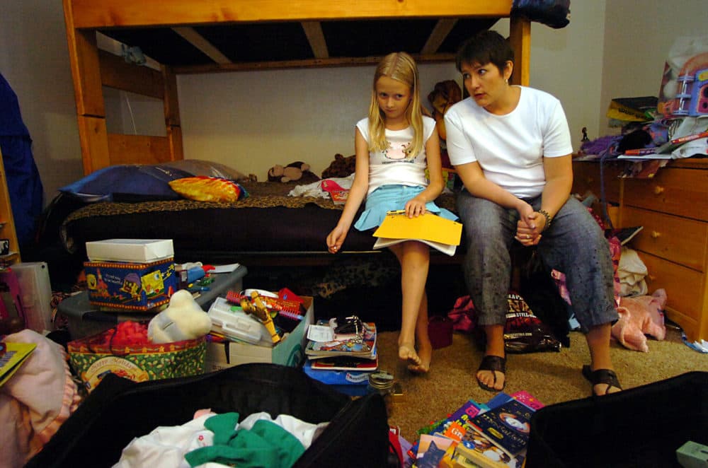 Aricia LaFrance, right, a psychologist and organizational consultant, advises Elphey Israel, 12, about cleaning and organizing her room at the Boulder Colo., apartment Elphey shares with her mother, Karen Lowe, Aug. 21, 2005. (Sammy Dallal/AP)