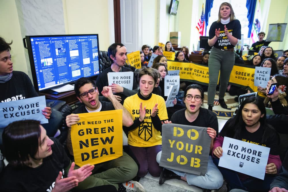 Environmental activists occupy the office of House Democratic Leader Nancy Pelosi of California, the speaker-designate for the new Congress, as they try to pressure Democratic support for a sweeping agenda to fight climate change, on Capitol Hill in Washington, Monday, Dec. 10, 2018. (J. Scott Applewhite/AP)