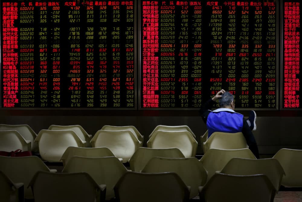 An investor monitors stock prices at a brokerage house in Beijing, Friday, Dec. 14, 2018, when Asian markets tumbled after China reported weaker-than-expected economic data, stirring up worries about the state of the world's second-largest economy. (Andy Wong/AP)