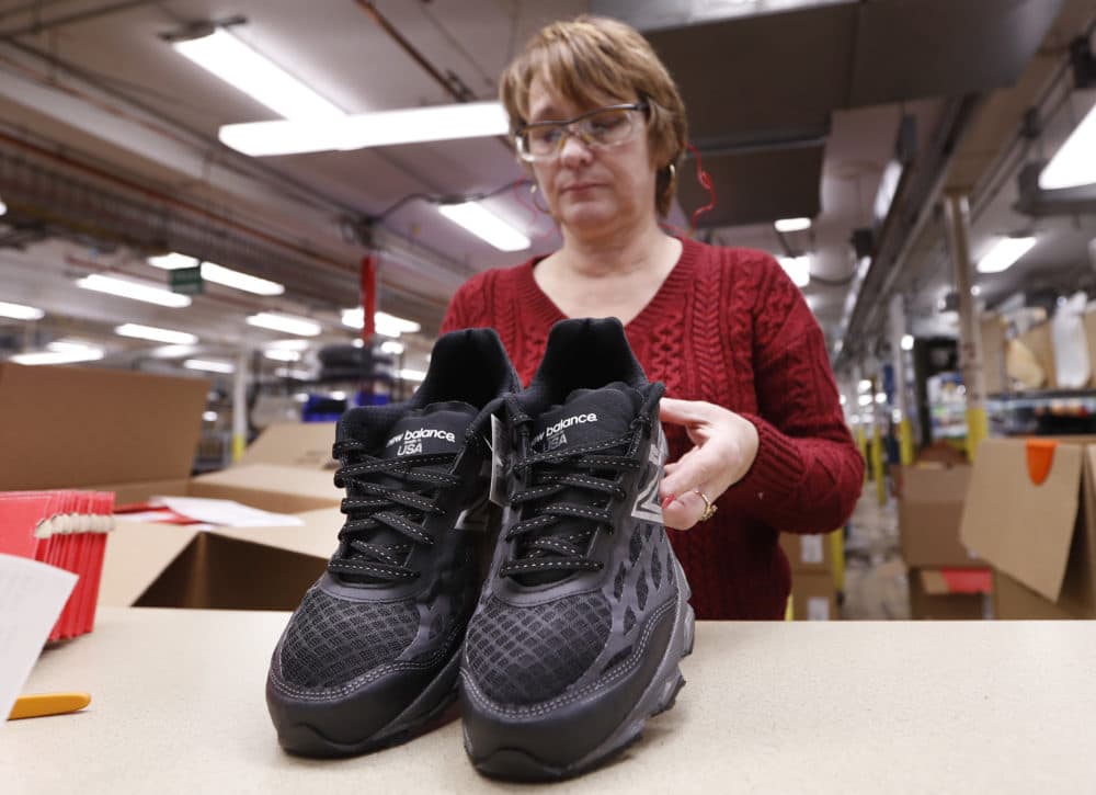 In this Monday, Dec. 17, 2018 photo, Ruby Williams inspects a pair of athletic shoes designed for the military at a New Balance factory in Norridgewock, Maine. The new contract fulfills a federal law requiring the military to outfit new recruits with American-made apparel. (Robert F. Bukaty/AP)