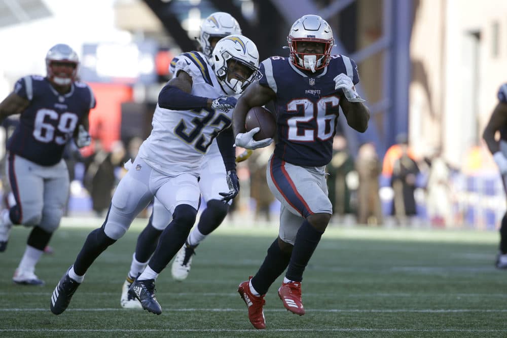 New England Patriots running back Sony Michel (26) runs away from Los Angeles Chargers free safety Derwin James (33) during the first half of an NFL divisional playoff football game, Sunday, Jan. 13, 2019, in Foxborough, Mass. (Steven Senne/AP)