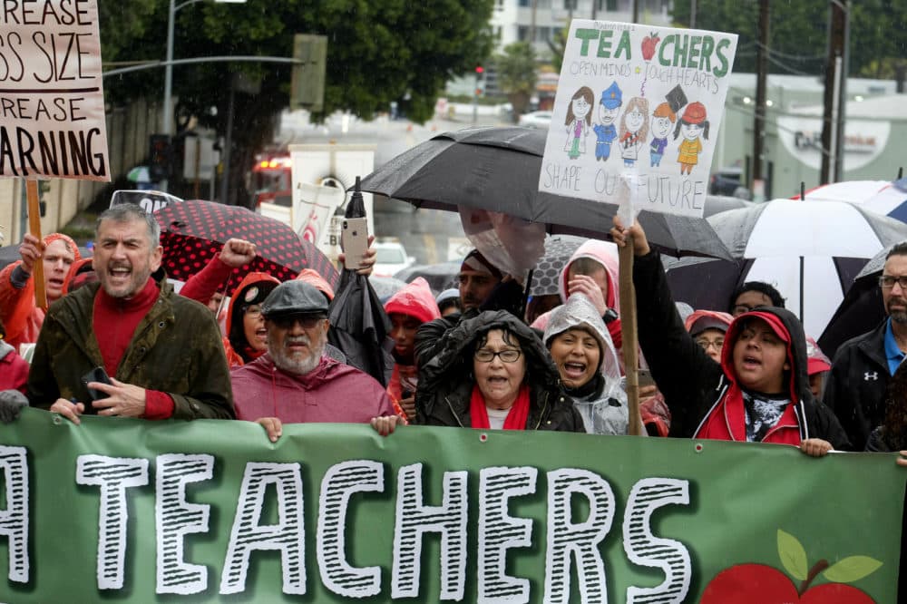 Thousands of teachers and supporters hold signs in the rain during a rally Monday, Jan. 14, 2019, in Los Angeles. (Ringo H.W. Chiu/AP)