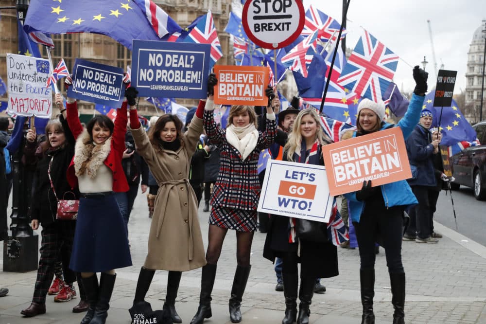 Leavers hold up signs next to pro-European demonstrators protesting opposite the Houses of Parliament in London, Tuesday, Jan. 15, 2019.(Frank Augstein/AP)