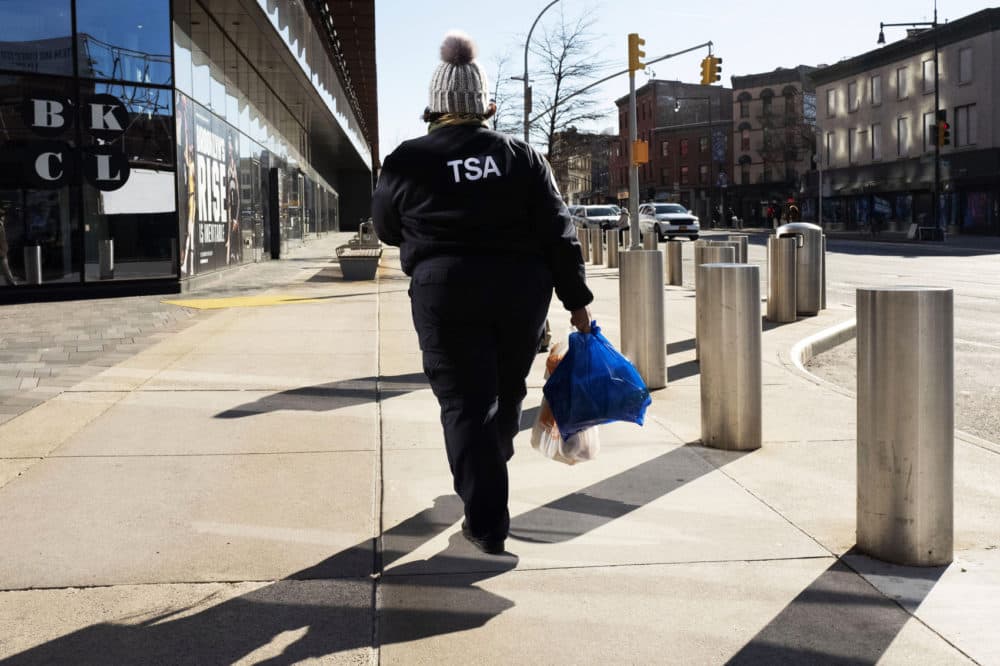 TSA worker Amelia Williams walks with bags of groceries after visiting a food bank for government workers affected by the shutdown, Tuesday, Jan. 22, 2019, in the Brooklyn borough of New York. (Mark Lennihan/AP)