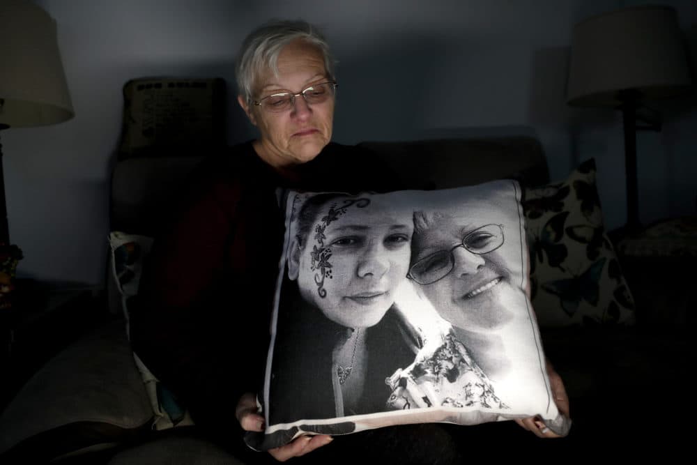 Deborah Fuller poses with a pillow showing a photo of her late daughter, Sarah Fuller, left, who passed away of a prescription drug overdose, and her during an interview in her home in West Berlin, N.J. The trial of a Insys Therapeutics Inc. founder John Kapoor, who is accused of scheming to bribe doctors into prescribing a powerful painkiller, is putting a spotlight on the nation's deadly opioid crisis. (Julio Cortez/AP)