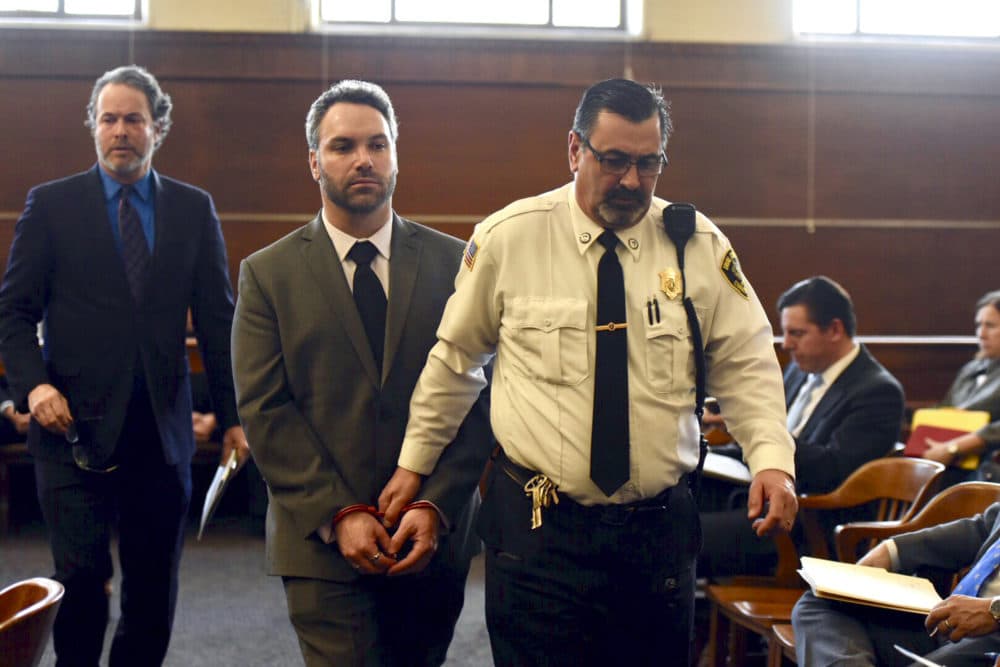 Mark Fitzgerald, of Ashland, Mass., is led by a district court officer Monday in Waltham, where he was arraigned on charges including assault with a dangerous weapon. (Faith Ninivaggi/MediaNews Group/Boston Herald via AP, Pool)