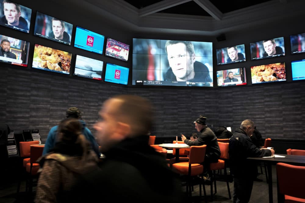 Patrons visit the sports betting area of Twin River Casino in Lincoln, R.I., on Monday. (Steven Senne/AP)
