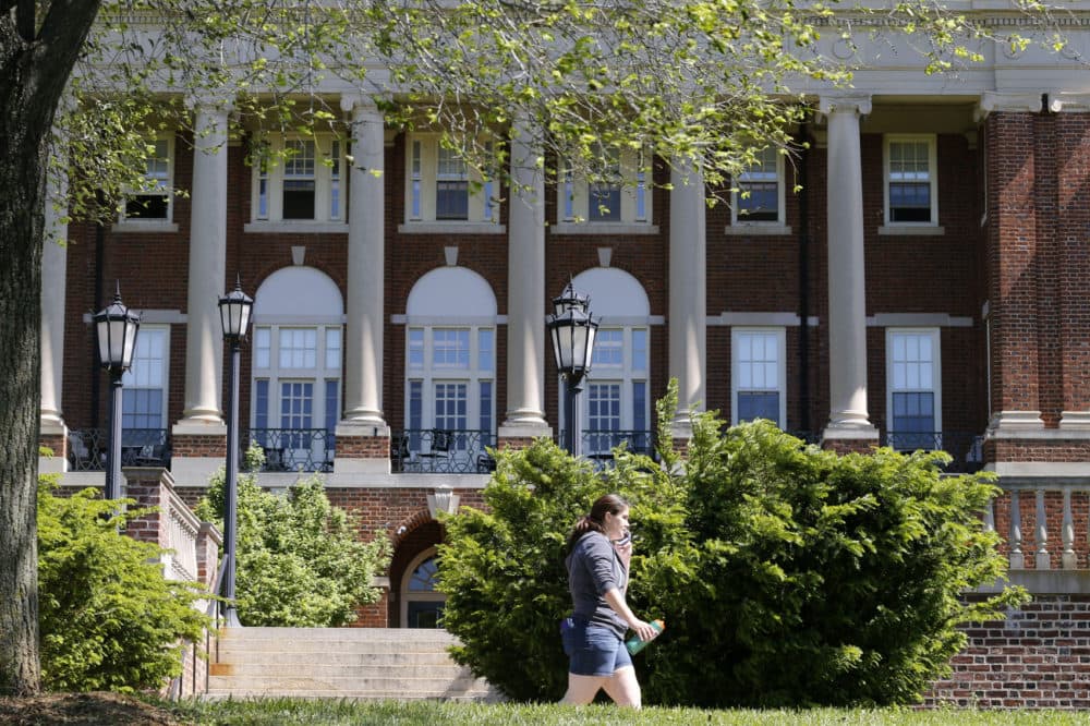 In this photo taken on Wednesday, May 13, 2015, a Sweet Briar College student walks past a building at the school in Sweet Briar, Va. The school nearly closed in 2015 amid financial difficulties. (Steve Helber/AP)