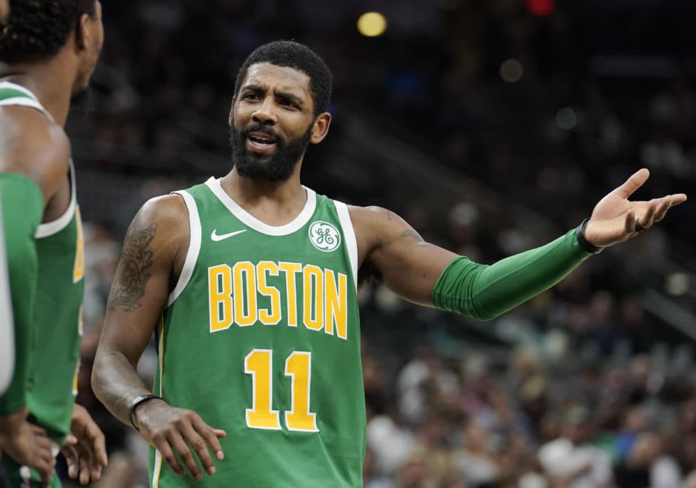Boston Celtics' Kyrie Irving talks to teammate Marcus Smart during a recent basketball game. He's been in the news for his criticism of another teammate. (Darren