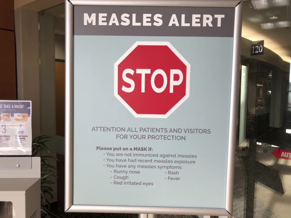 In this Jan. 30, 2019 file photo signs posted at The Vancouver Clinic in Vancouver, Wash., warn patients and visitors of a measles outbreak. A measles outbreak near Portland, Ore., has revived a bitter debate over so-called personal belief exemptions to childhood vaccinations. (Gillian Flaccus/AP)