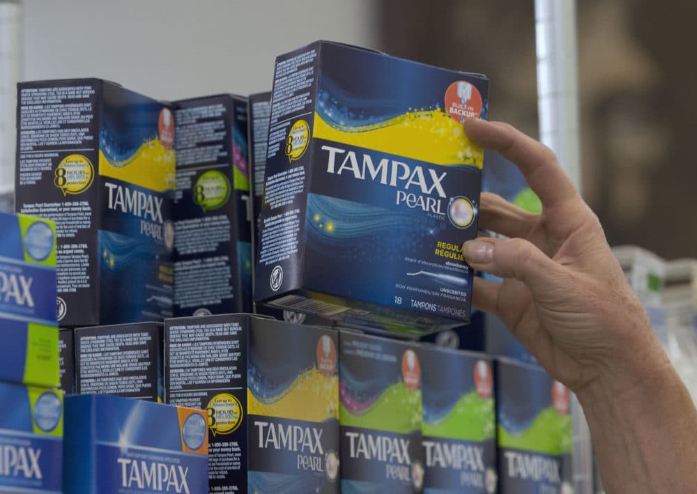 Tammy Compton restocks tampons in Sacramento, California. (Rich Pedroncelli/AP)