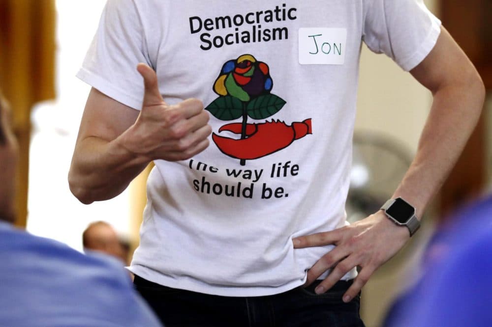 A demonstrator wears a T-shirt promoting democratic socialism during a gathering of the Southern Maine Democratic Socialists of America at City Hall in Portland, Maine, Monday, July 16, 2018. (Charles Krupa/AP)