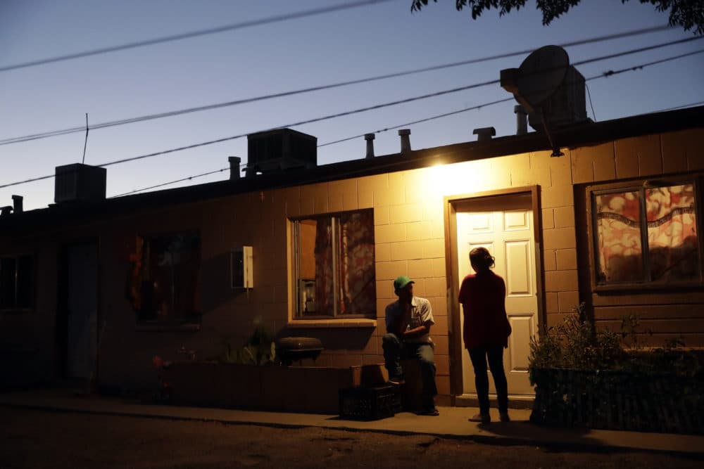 In this Wednesday, Sept, 19, 2018 photo, the sun sets behind an apartment building occupied by farmworkers in Huron, Calif. California may be famous for its wealth, but there is a distinctly different part of the state where poverty prevails: places like this one halfway between Los Angeles and San Francisco. The Central Valley has long been short on resources no matter which political party is in power. (Marcio Jose Sanchez/AP)