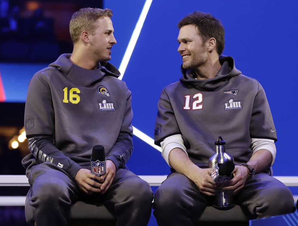 Los Angeles Rams' Jared Goff talks to New England Patriots' Tom Brady during Opening Night for the NFL Super Bowl 53 football game in Atlanta. The wide-eyed, talented Goff will try to lead his Rams past the grizzled, 41-year-old Brady, who is looking to guide the Patriots to their sixth Super Bowl victory. 
 (Matt Rourke/AP)