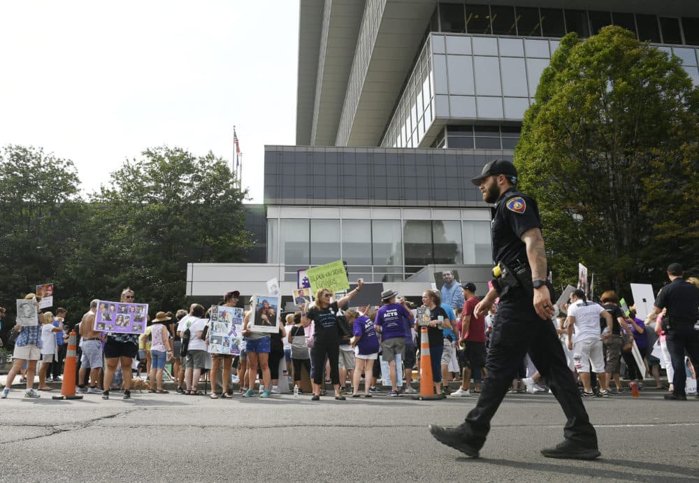 Family and friends who have lost loved ones to OxyContin and opioid overdoses protest outside Purdue Pharma headquarters in Stamford, Conn., in August 2018. (Jessica Hill/AP)